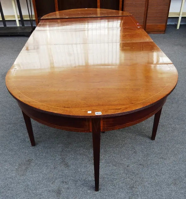A George III style inlaid mahogany extending 'D' end dining table, with pair of semi-elliptic consoles and drop flap centre, with two extra leaves,122