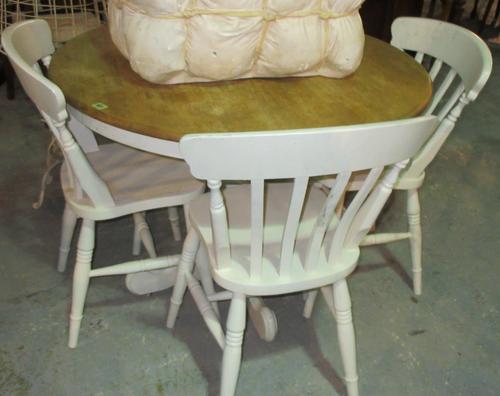 A 20th century circular top hardwood dining table, on white painted quadripartite base, 100cm wide x 78cm high and a set of four white painted stick b
