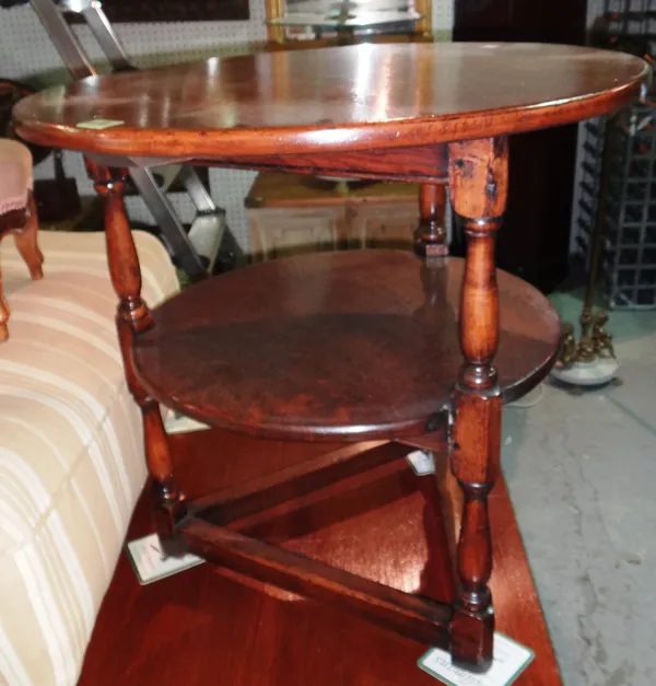 A 20th century oak circular two tier occasional table with perimeter stretcher, 62cm wide. G8