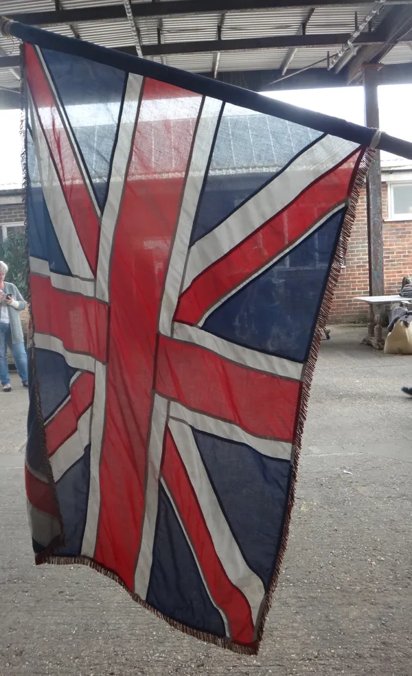 A 20th century Union Flag and pole, 420cm high.  OUT