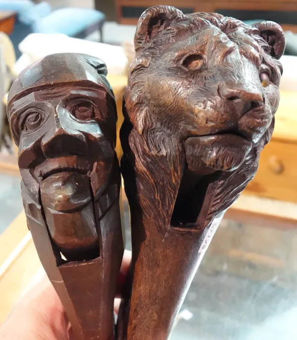 A Victorian novelty carved wooden nutcracker formed as a lions head and another of Mr Punch, approx 21cm high, (2).    CAB