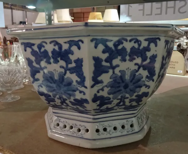 A Chinese porcelain blue and white jardiniere, 20th century, of octagonal form, painted with flowers, 23cm high.  A8