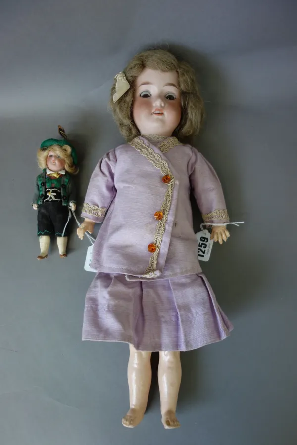 An Armand Marseille bisque head child doll, early 20th century, mould no.390, with sleep eyes, open mouth and jointed limbs, 40cm, and a small German