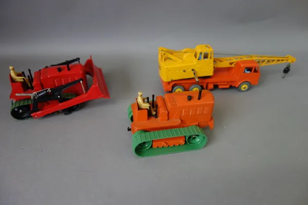 Three dinky commercial vehicles; 563 Heavy tractor, 972 20 tonne lorry mounted crane 'Coles' and 561 Blaw Knox bulldozer, all boxed, (paint refreshed