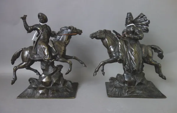A pair of patinated bronze equestrian figures, early 20th century an Ottoman gentleman and a lady riding side saddle, each on a naturalistic rectangul