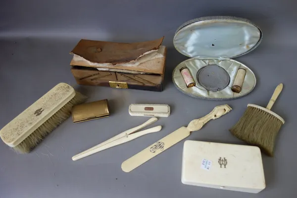 A Georgian ivory and inlaid toothpick box of canted rectangular form, 9cm, a Victorian ivory part dressing table set with inlaid brass monogram, and r
