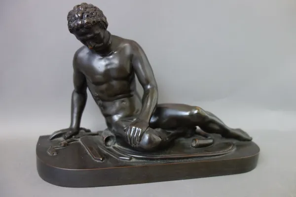 A patinated bronze 'Dying Gaul', circa 1900, on a shaped integral plinth, unsigned, 31.5cm wide.  Illustrated