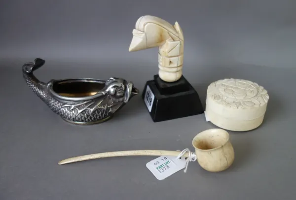 An early 19th century carved ivory kris handle, 7cm long, a foliate carved ivory circular pot and cover, 6.5cm diameter, a carved bone ladle and a whi