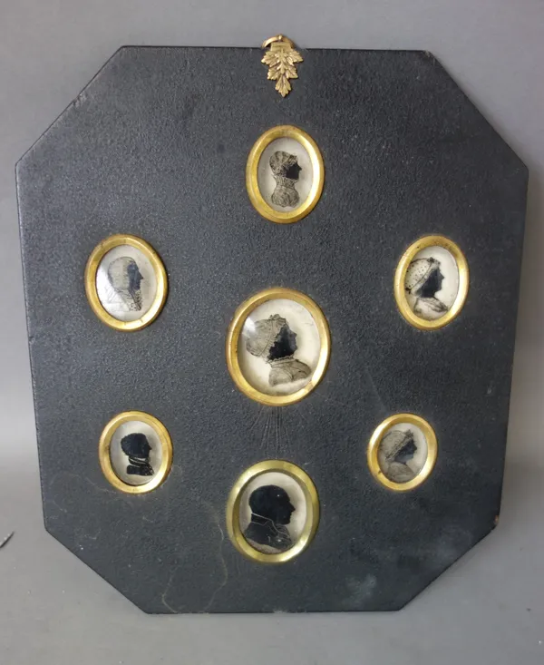 Six Victorian wax profile busts depicting classical historical figures, 4cm high, framed as one, and seven Georgian silhouettes on glass, also framed