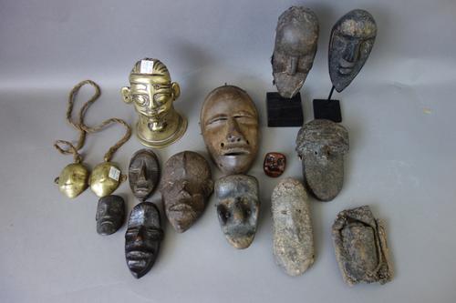 A quantity of African small wooden tribal masks, approximately 12cm high, and further similar African brass tribal items, (qty).