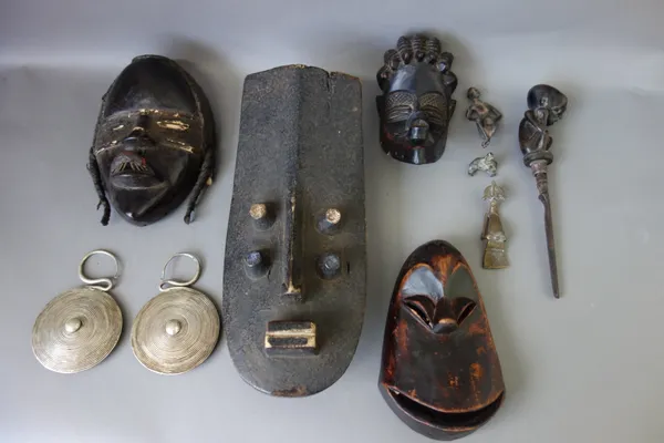 A quantity of tribal related items, including; African wooden masks, brass Ashanti figures, a feather headdress, a Middle Eastern jambia, beadwork bag