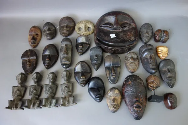 A quantity of tribal related items, including; a large pair of 'Fulani' gilt metal ceremonial earrings, 19cm, small African wooden masks, African meta