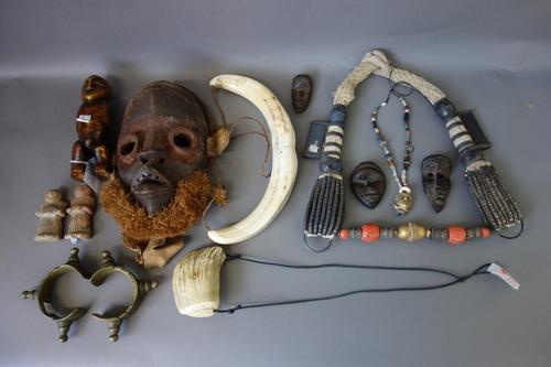 A quantity of mainly African tribal items, including; a faux ivory fertility figure, 16.5cm high, a cord and metal mounted ceremonial necklace, Africa