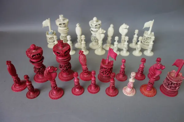 A Cantonese stained ivory chess set, early 20th century, of pierced foliate form, the king 10.5cm high.  Illustrated