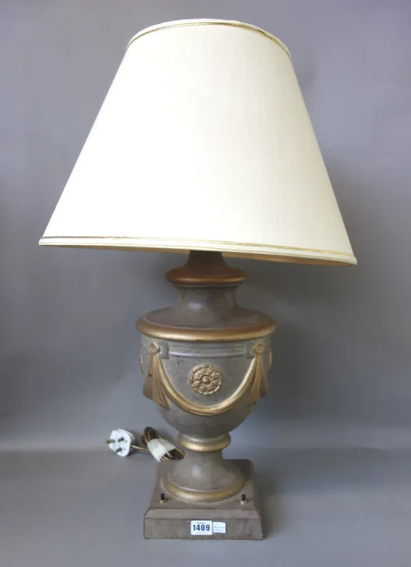 A pair of modern pottery table lamps, each of urn form, relief moulded with gilt swags against a brown ground, with cream shades, 70cm high, (2).