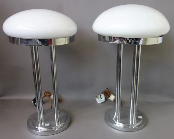 A set of four Art Deco style chrome and glass table lamps, each stepped circular base issuing four pillars, supporting a domed opaque glass shade, 50c