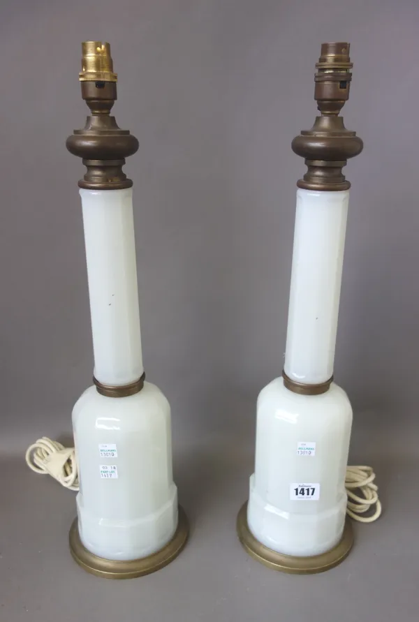 A pair of Victorian style opaque glass and brass mounted table lamps, of sectional faceted form, with cream silk pleated shades, 47cm high excluding f