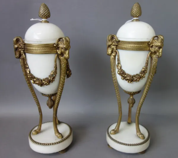 A pair of late 19th century French gilt bronze and white marble cassolettes in the Louis XVI style, each with pineapple finial and rams head masks, ra