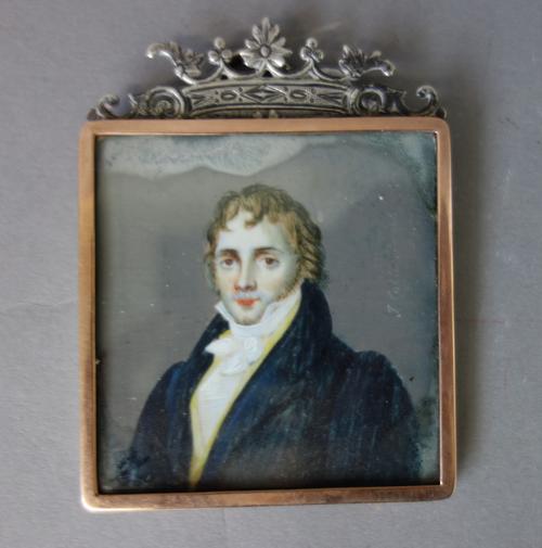 Early 19th century English School, a portrait miniature on ivory of a young man in blue coat, with black collar and gilt buttons, the image 6.3cm high
