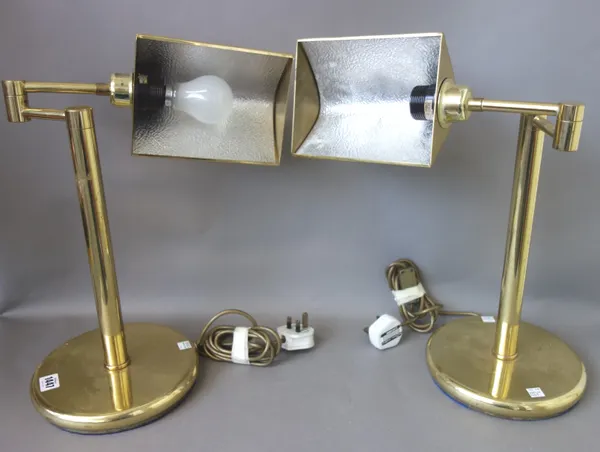 A pair of modern gilt metal desk lamps, each with adjustable shade over a loaded circular base, 41cm high, (2).