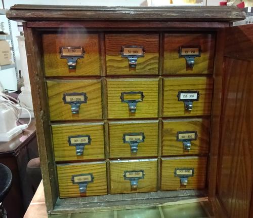 A 20th century keystone view oak photographic slide cupboard, with panel door revealing twelve drawers.  D4