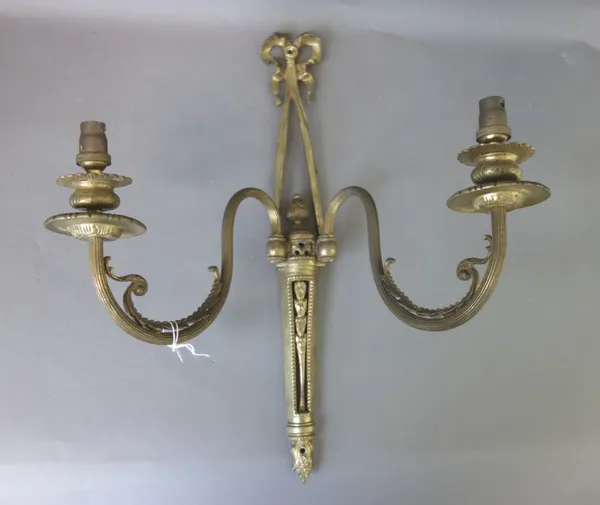 A set of six Empire style gilt brass twin branch candelabra, modern, each foliate cast backplate with ribbon surmount, issuing two fluted swan neck br