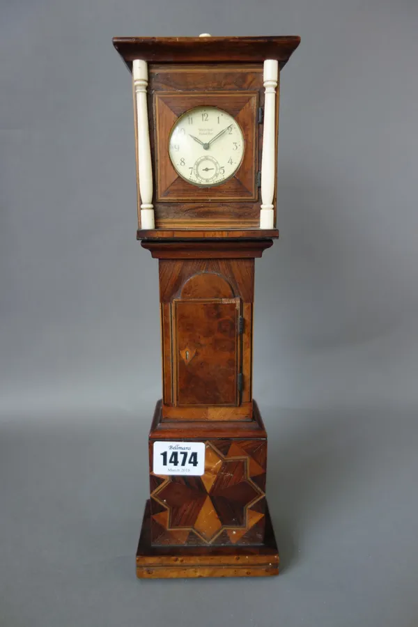A late 19th century novelty pocket watch holder, formed as a parquetry decorated miniature longcase clock, 31.5cm high.  Illustrated