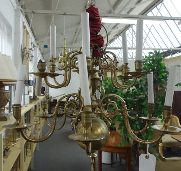 A Dutch style brass eleven branch chandelier, 19th century, the bulbous stem issuing eleven scroll work branches over two graduated tiers. 65cm high.