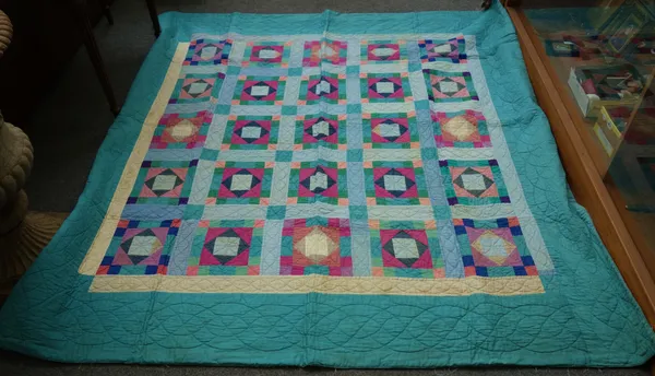 A Victorian style patchwork quilt, 20th century, with multi-coloured squares against a turquoise ground, 200cm x 190cm, and another quilt of more trad