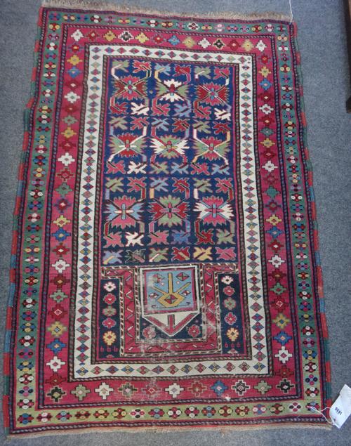 A Karabagh prayer rug, early 20th century, the arched main field enclosing polychrome leaf and flower motifs within white pink and green borders, 137c