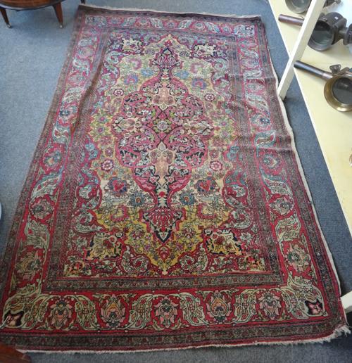 An Esfahan rug, with a brushed yellow foliate field with central medallion and red foliate palmette and leaf main border, 140cm x 221cm.