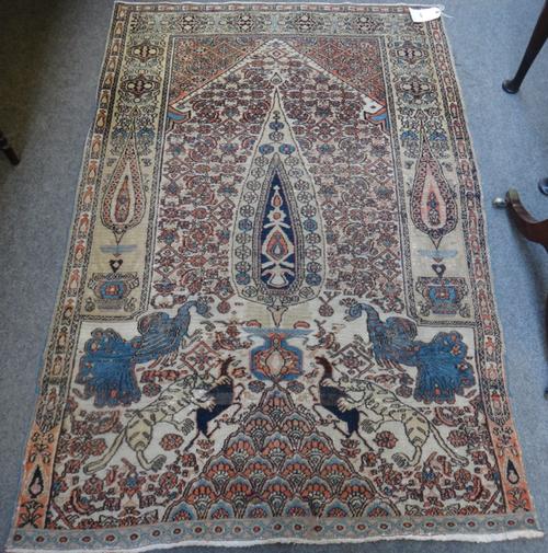 A Doruksh rug, North east Persian, the arched field with a vase and tree, with hunting scenes, 115cm x 168cm.