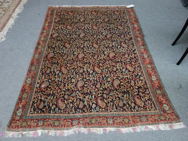 A Senneh rug with dark field with foliate boteh all over design, 129cm x 203cm.