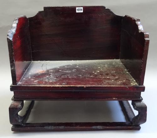 An early 20th century Chinese cat bed, with three quarter shaped sides, on shaped supports, 51cm wide x 46cm high x 38cm deep.