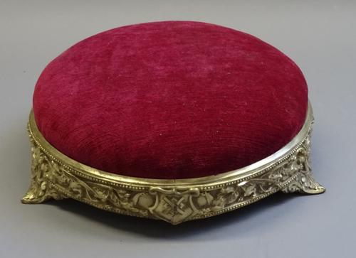 WT & S; a late Victorian gilt metal framed circular footstool, with dragon relief decoration, impressed registration lozenge, 30.5cm diameter, 11cm hi
