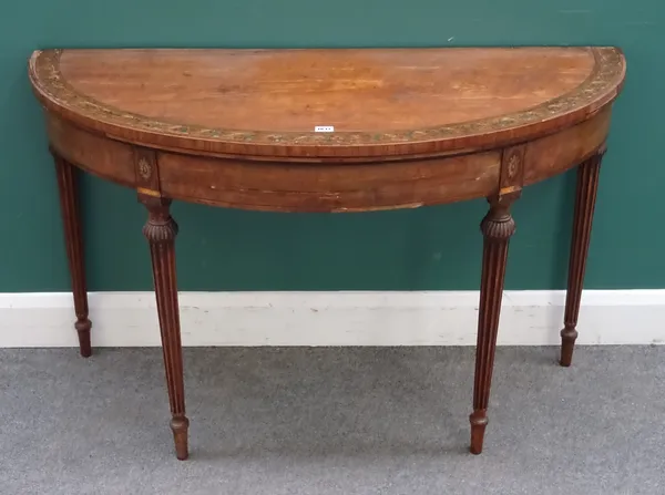 A George III inlaid polychrome painted satinwood card table, possibly Irish, the semi-elliptic foldover top on tapering fluted supports, 122cm wide x