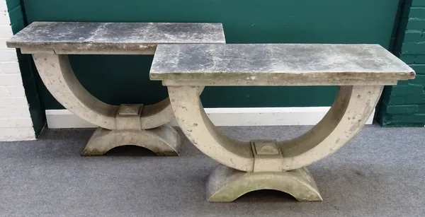 A pair of faux stone console tables, each with rectangular slab tops on open 'U' shaped undertier, 120cm wide x 80cm high x 44cm deep.