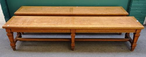 A pair of late Victorian oak benches, each on six tapering square supports united by stretcher, 200cm wide x 40cm deep x 46cm high.