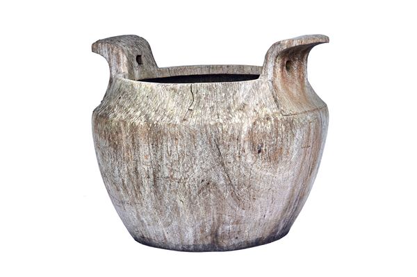 An Eastern dug out carved hardwood large carrying bowl, with a pair of splayed handles, 105cm wide x 77cm high.  Illustrated