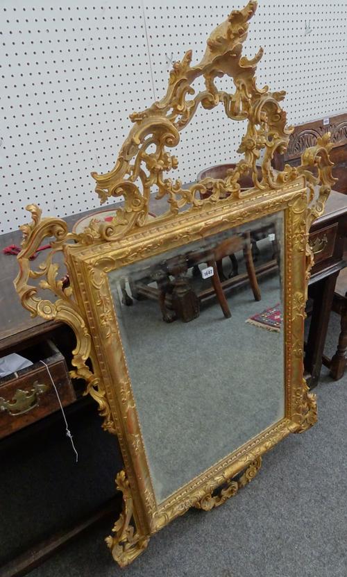 A North Italian giltwood mirror in the Rococo style, 95cm wide x 143cm high