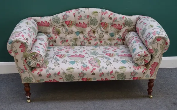 A modern hump back sofa, of small proportions, with floral upholstery, rollover arms on turned supports, 140cm wide x 78cm high x 56cm deep.