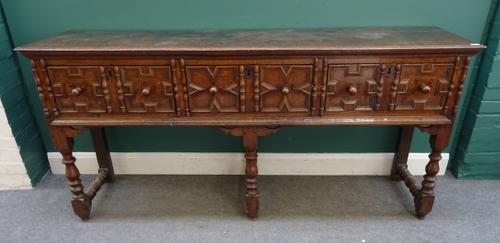 A Charles II and later oak dresser base, with three geometrically moulded frieze drawers, on baluster turned supports, 190cm wide x 87cm high x 49cm d