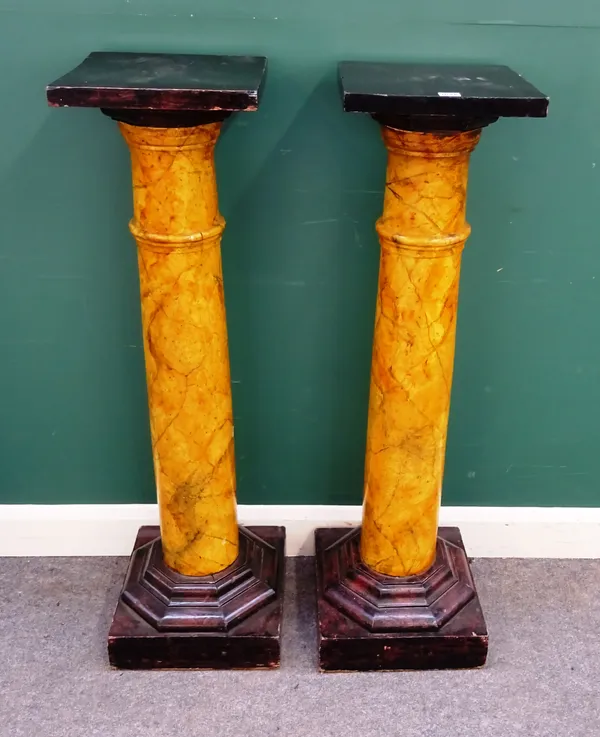 A pair of jardiniere stands, each with ebonised square top over faux marble painted column, on octagonal base, 35cm wide x 117cm high.
