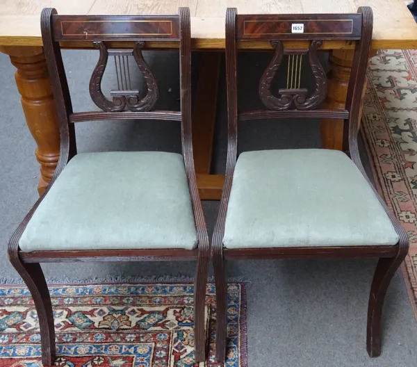 A set of twenty-two Regency style brass inlaid mahogany dining chairs, with lyre back and sabre supports, (22).