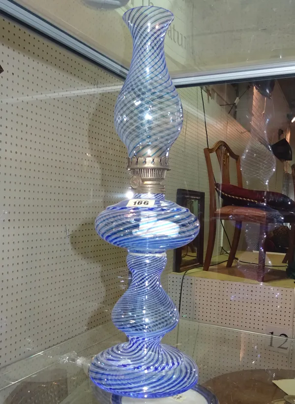 A 20th century glass oil lamp, with blue swirl decoration and shade. C