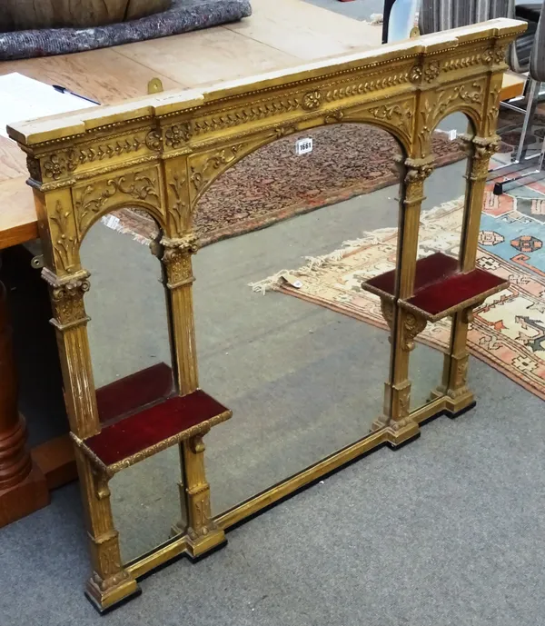 A Victorian gilt framed overmantel mirror, with triple arch plate and pair of shelves, 108cm wide x 92cm high.