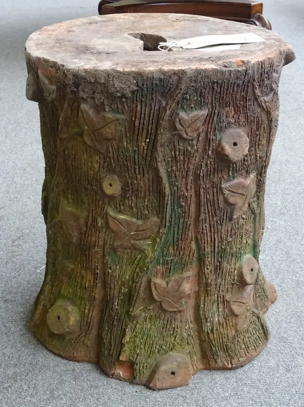 A pair of terracotta garden seats, naturalistically moulded as ivy entwined tree stumps, 35cm diameter x 45cm high.