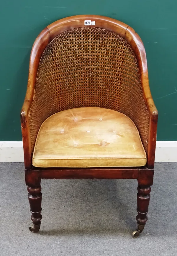 A William IV walnut framed tub back library bergere on turned supports, 55cm wide x 89cm high.