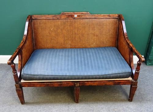 An 18th century plantation style hardwood framed sofa with rush back and sides on channeled tapering square supports. 130cm wide x 85cm high.