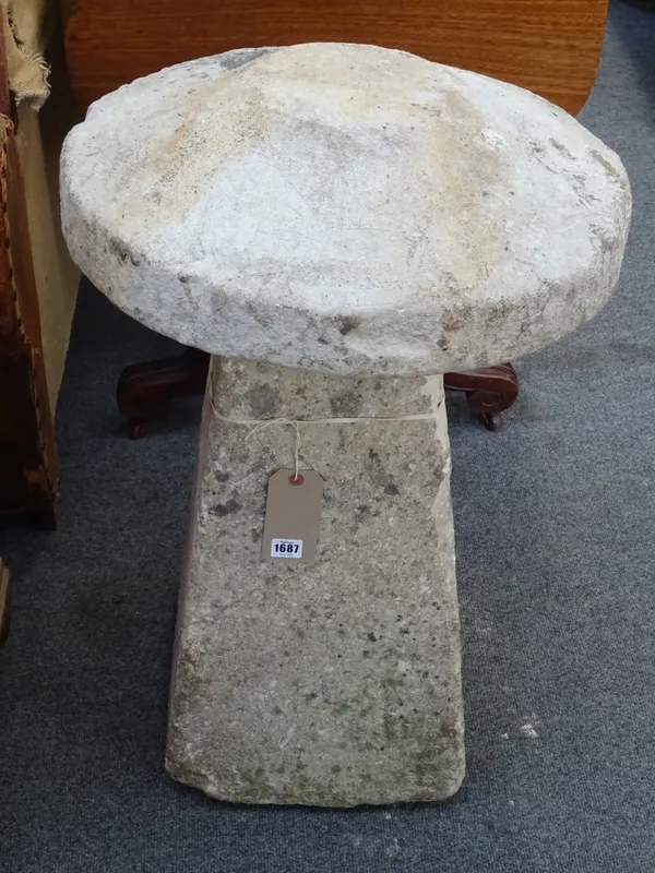 A pair of carved stone staddle stones, each with circular tops on tapering square bodies, approx 47cm diameter x 65cm high.